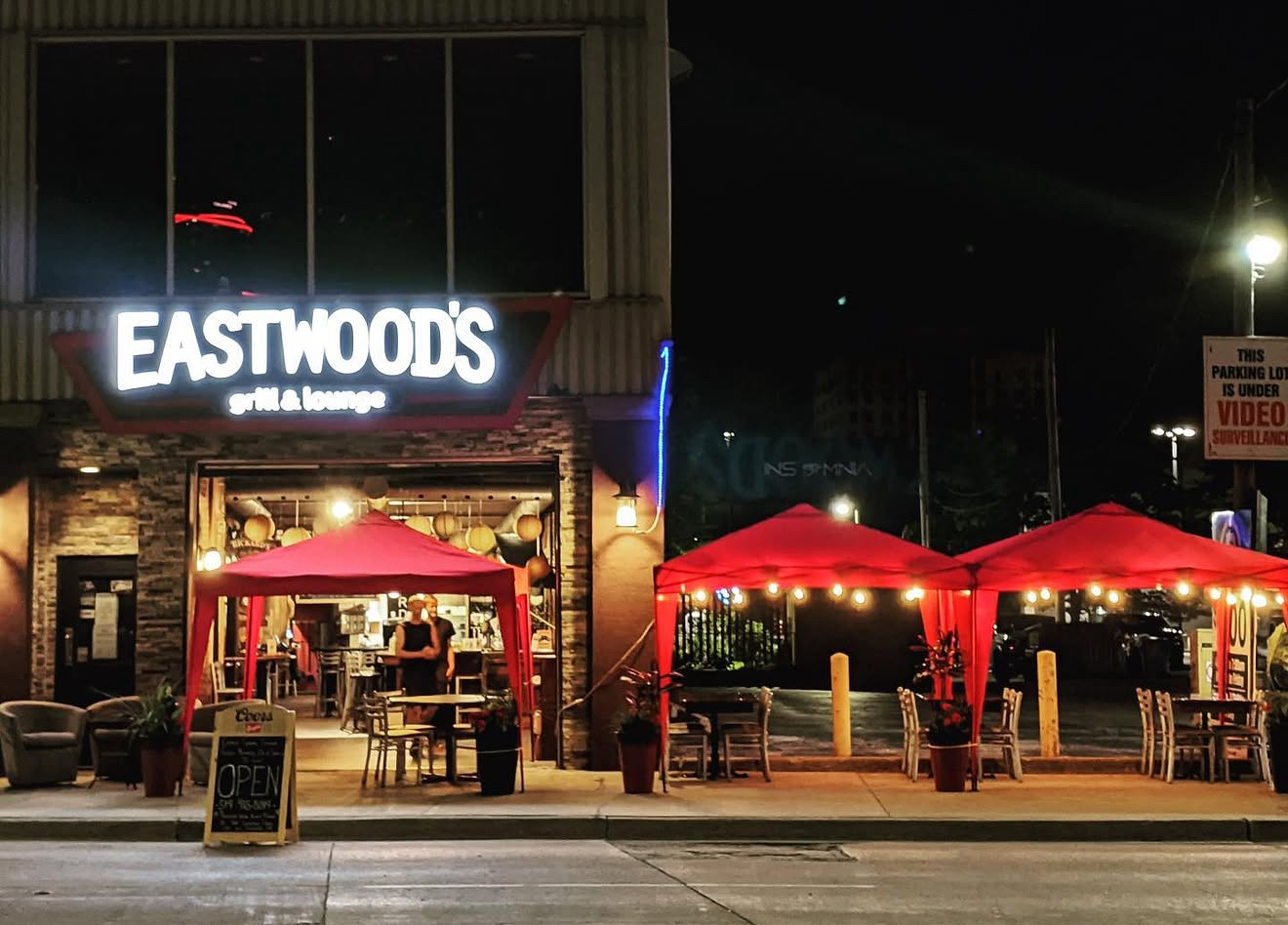 Eastwood's patio at night under red tents