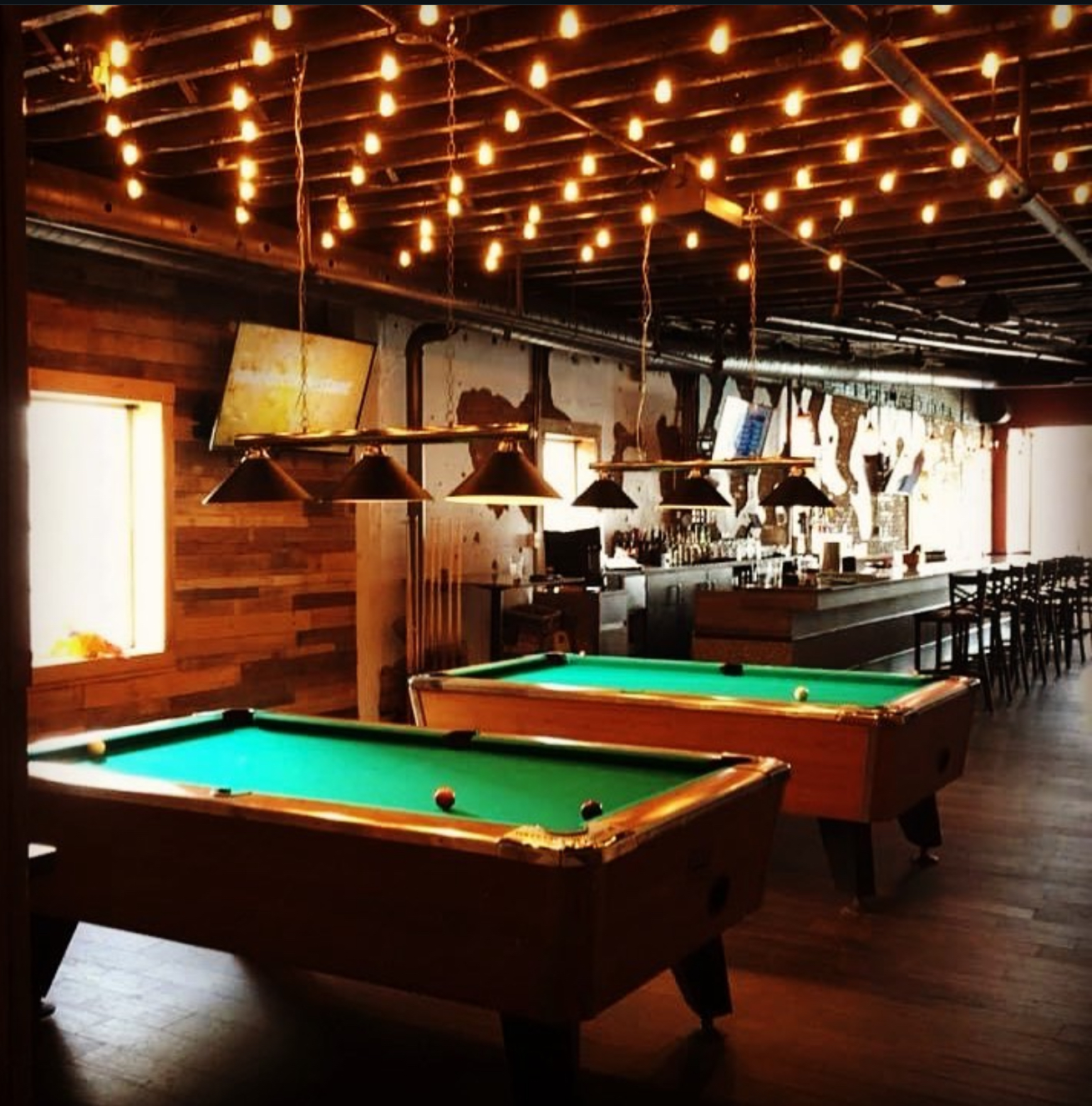 Pool tables under string lights
